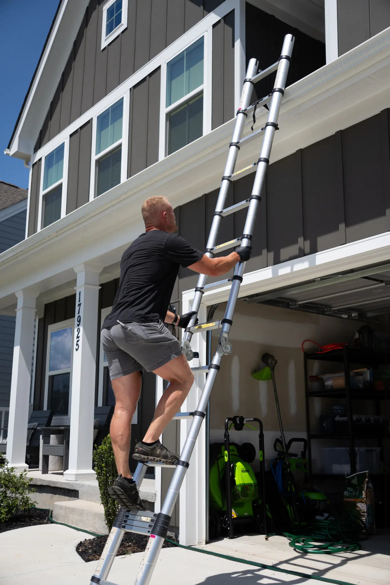 Save Big with Bundled Home Inspection Packages Today! A worker climbs an extension ladder beside a home's exterior.