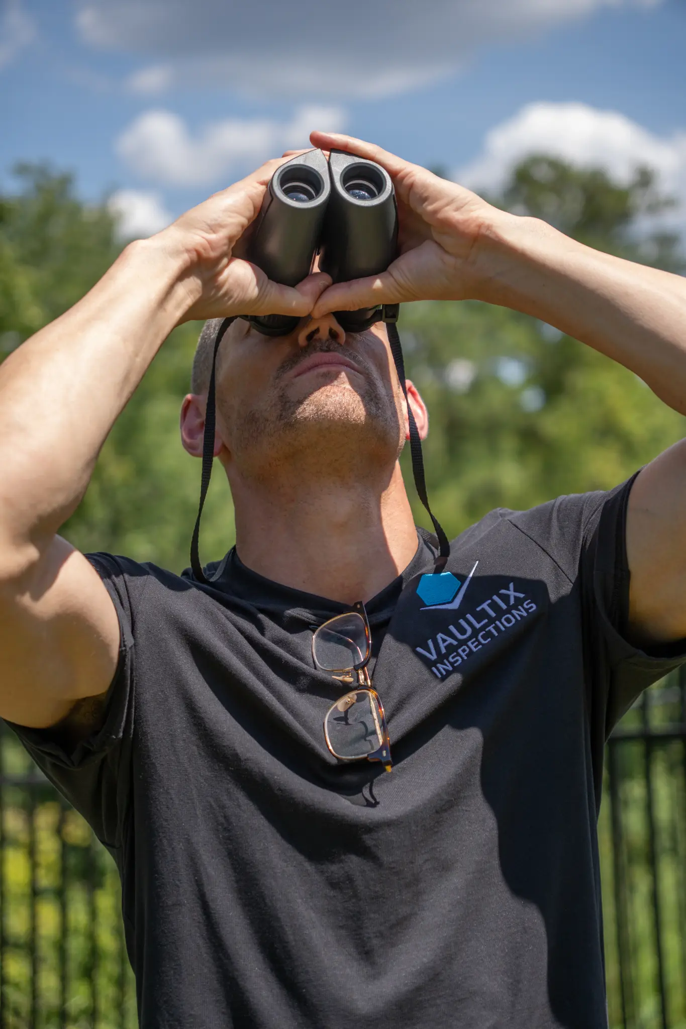 Ensure Safety: Test Your Home for Radon Mitigation Today A person in a dark shirt looks through binoculars outdoors.